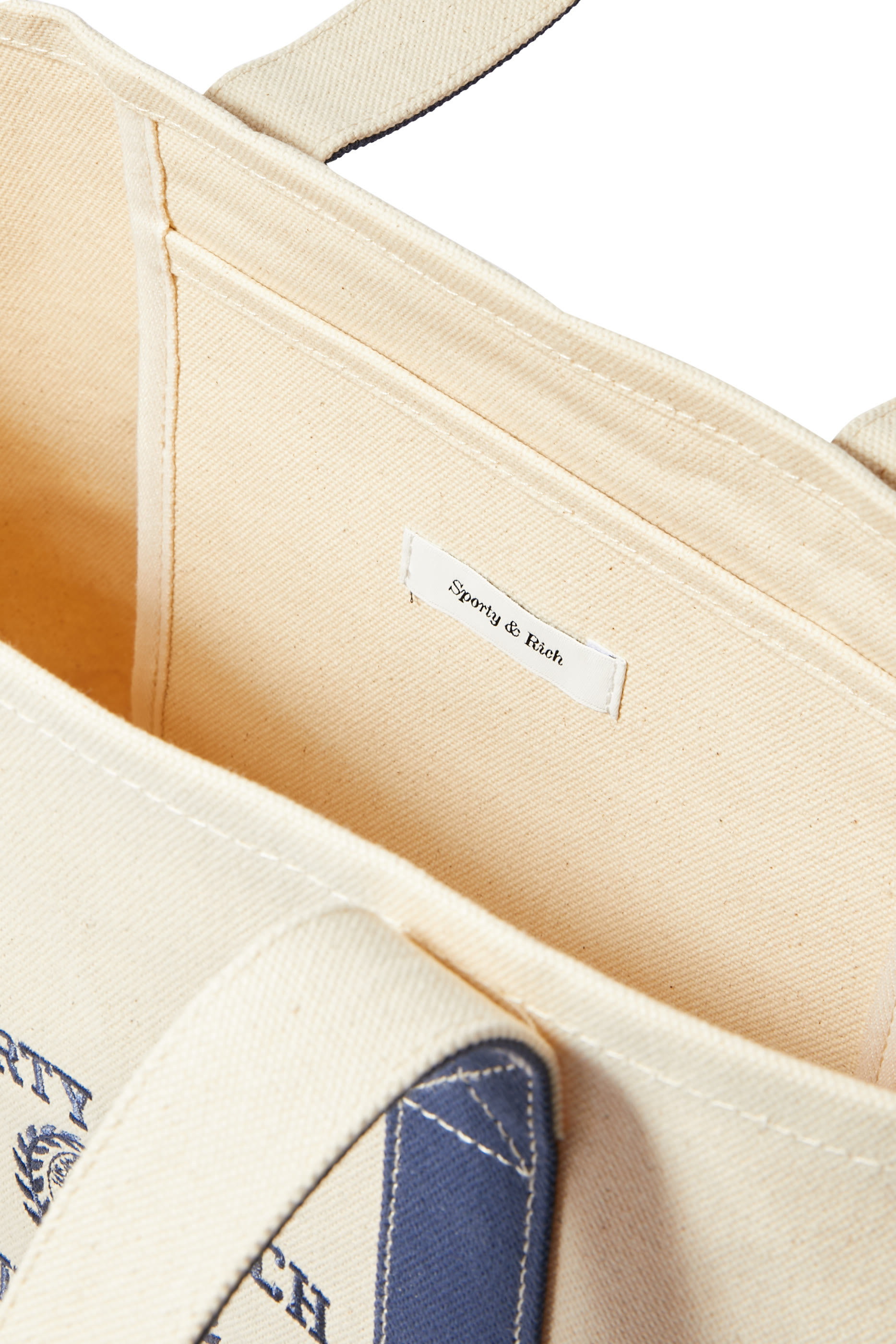 حقيبة يد بلونين ونقشة شعار الماركة بتصميم جامعي