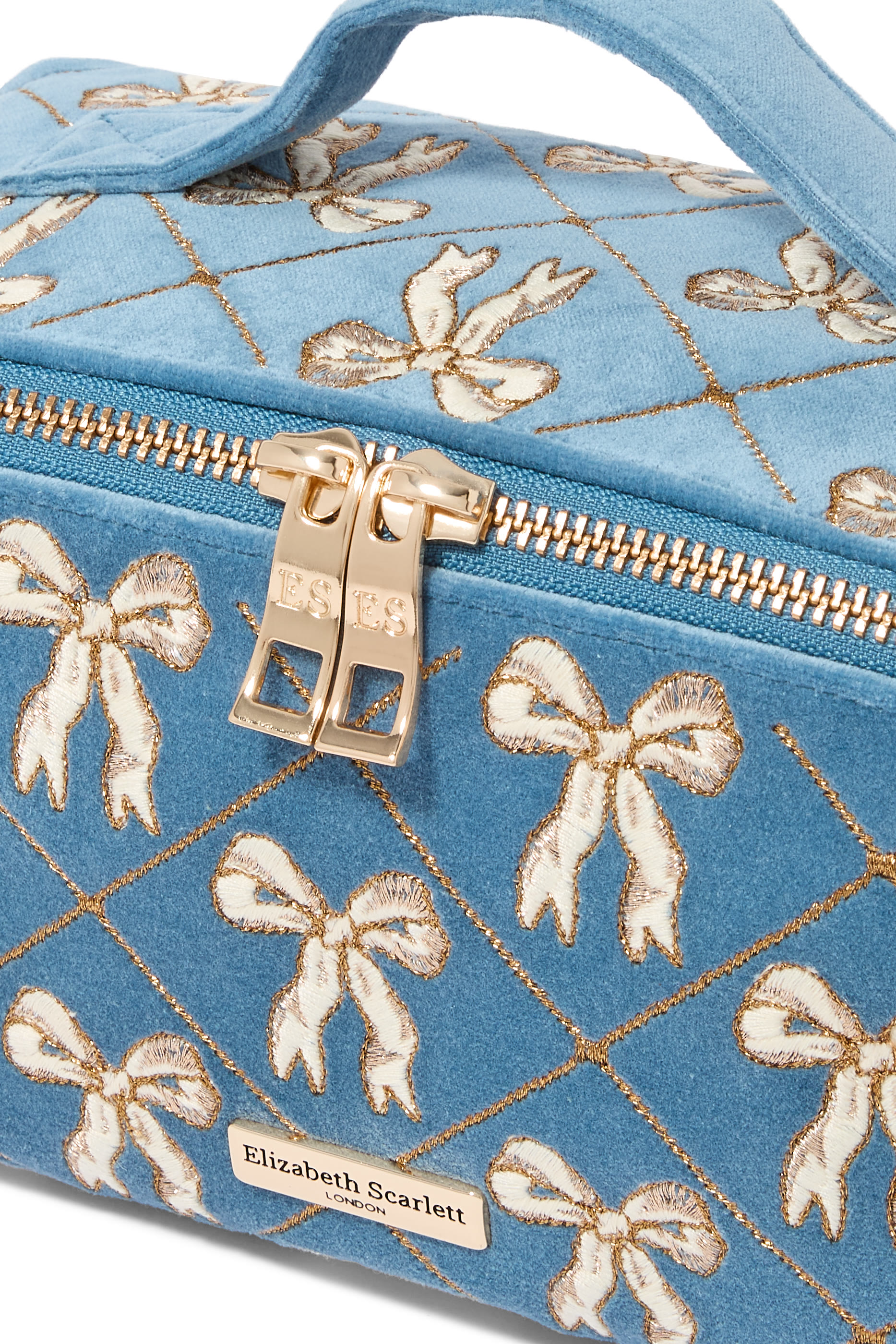 حقيبة مستحضرات التجميل مفتوحة ومسطحة مزينة بفيونكات مخمل