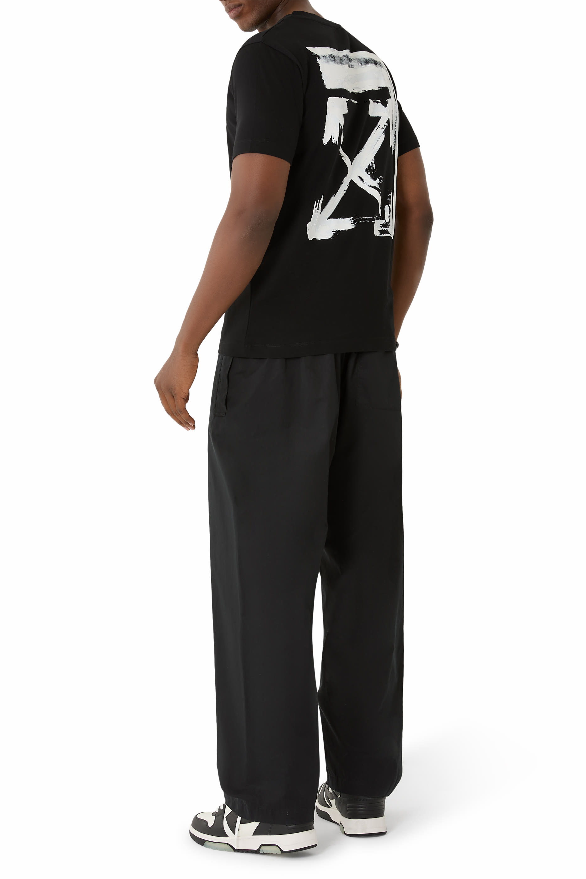 تيشيرت بقصة ضيقة وشعار الماركة مزين بطبعة أسهم وحبر