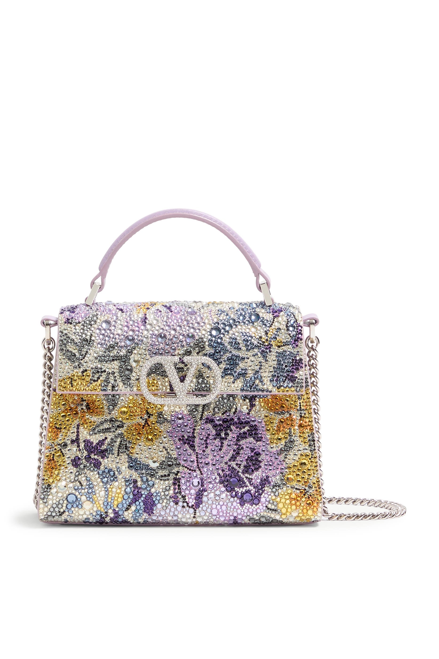 حقيبة بيد علوية وحلية شعار الماركة